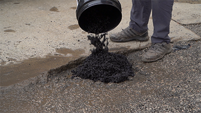 Application - fill hole from bag of asphalt patch